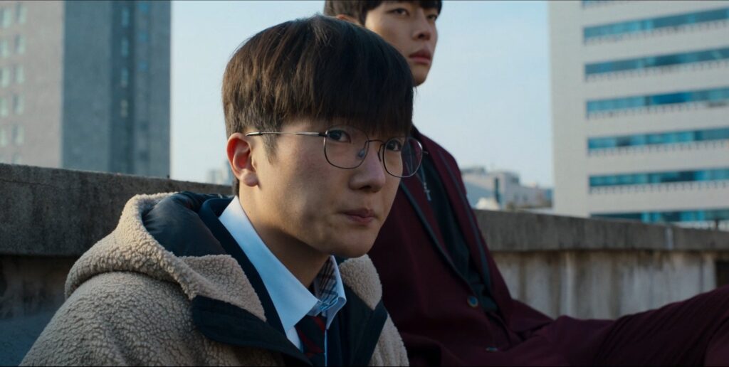 "Jun-tae watching helplessly as Go-tak gets overwhelmed by Seong-je - a heartbreaking moment showing his loyalty and concern for his best friend. Source: Weak Hero Class 2, Netflix"