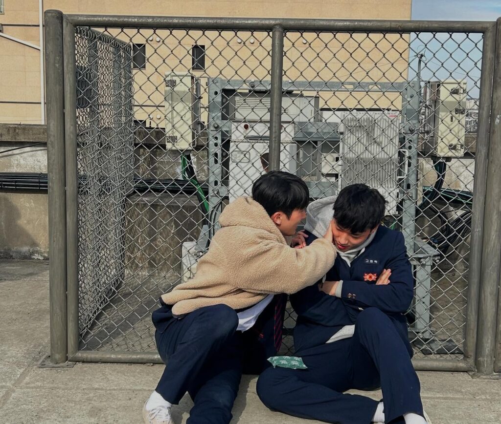 "Behind-the-scenes shot of Lee Min-jae (Go-tak) and Choi Min-young (Jun-tae) during filming - the real-life friendship between these actors that translated perfectly into their on-screen chemistry. Source: Weak Hero Class 2 behind-the-scenes, Netflix"