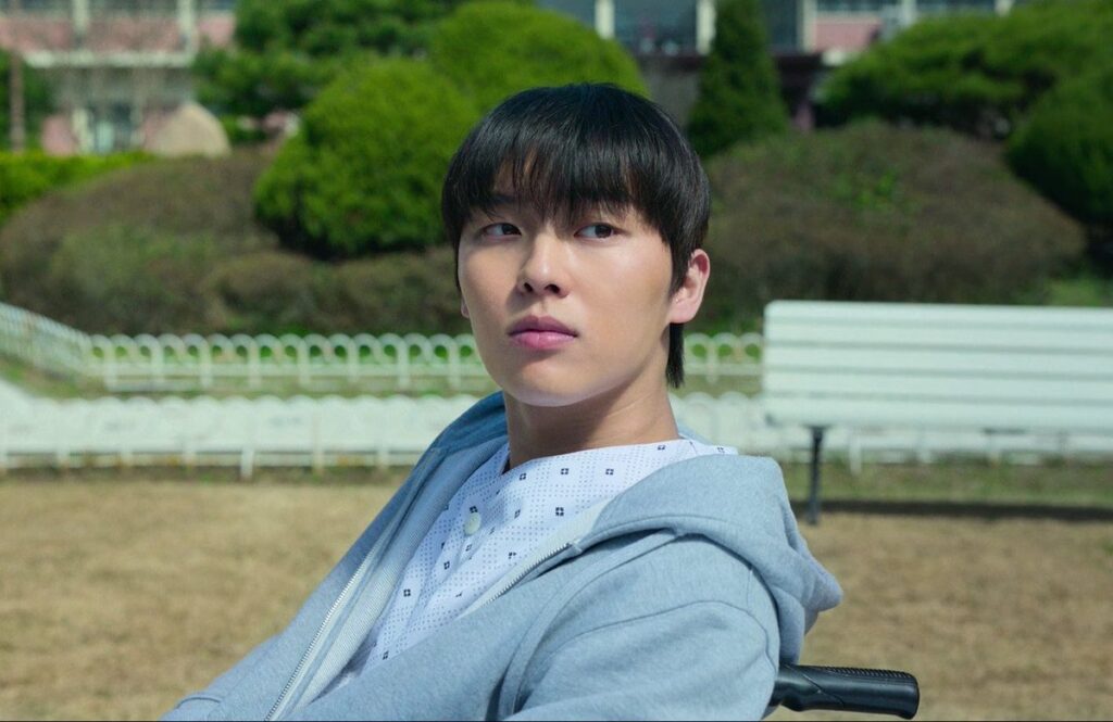 "Screenshot from Weak Hero Class 1 showing Choi Hyun-wook as Ahn Su-ho opening his eyes in a hospital bed, depicting his recovery from the injuries sustained in the underground fight."