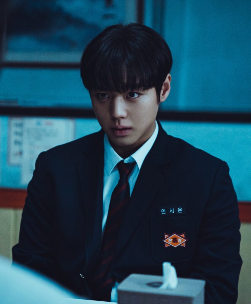 "Si-eun's sharp, intense gaze - the piercing look that reveals his analytical mind and the underlying violence that Su-ho's friendship helped him navigate. Source: Weak Hero Class 1, Wavve/Netflix"