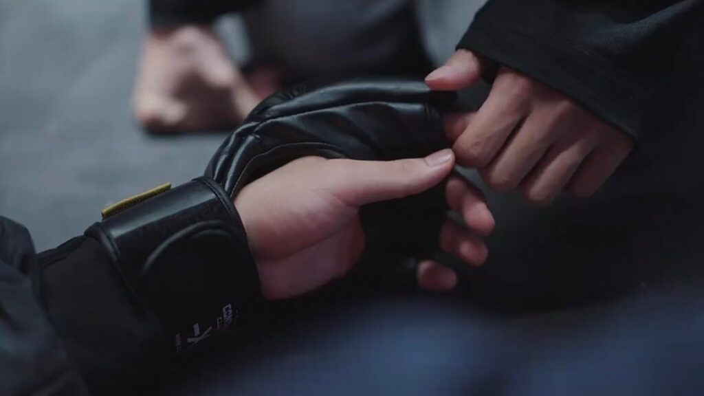 "Beom-seok holding Su-ho's unconscious hand like a child - a haunting image that captures the complex mix of love, guilt, and desperation in his character after the tragic ring incident. Source: Weak Hero Class 1, Wavve/Netflix"