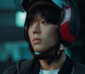 "Screenshot of actor Park Ji-hoon as Yeon Si-eun wearing a motorcycle helmet while looking at Su-ho in Weak Hero Class 1, showing a moment of trust and growing friendship between the characters."