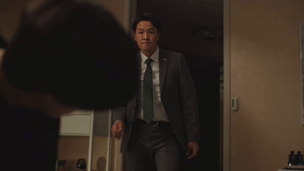 "Screenshot from Weak Hero Class 1 showing Oh Jin-won, Beom-seok's adoptive father, in an act of domestic violence against Hong Kyung as Oh Beom-seok, illustrating the abusive relationship that shaped Beom-seok's psychology."